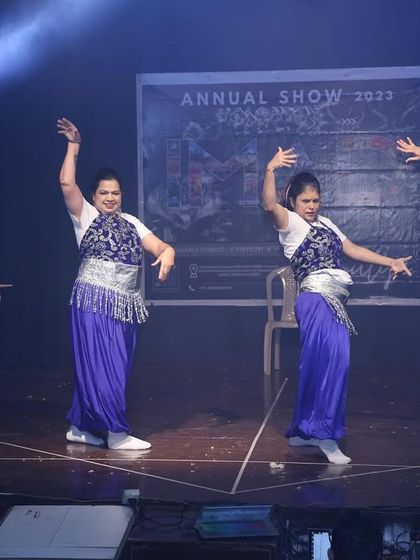 Our ladies' batch performs a fun, upbeat number in stylish purple and silver costumes.