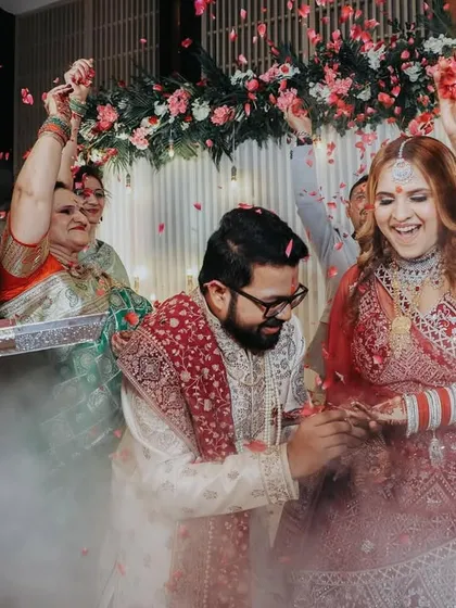 The grand ring exchange moment, surrounded by family and a shower of petals. I use effects like smoke to add a touch of drama to these key events.