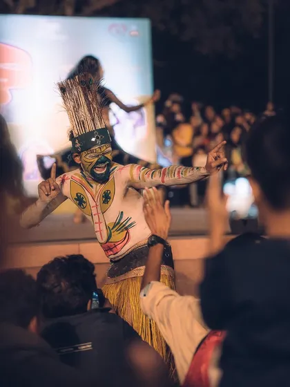 A performer interacts with the audience, bringing the energy of the stage directly to the crowd. Capturing these connections is key to telling the full story of an event.