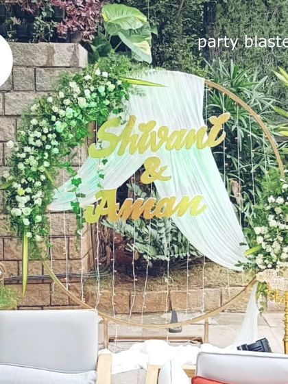 The same anniversary backdrop in a different light, showcasing its versatility and the beauty of the white floral arrangements against the natural greenery.