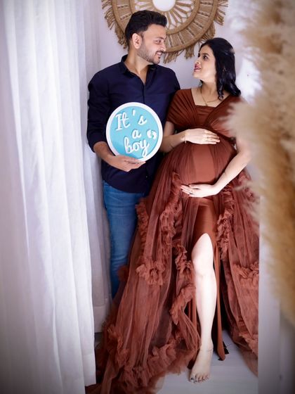 A bright and happy gender reveal. The couple looks at each other with love as they announce "It's a boy" in our airy, naturally lit studio corner.