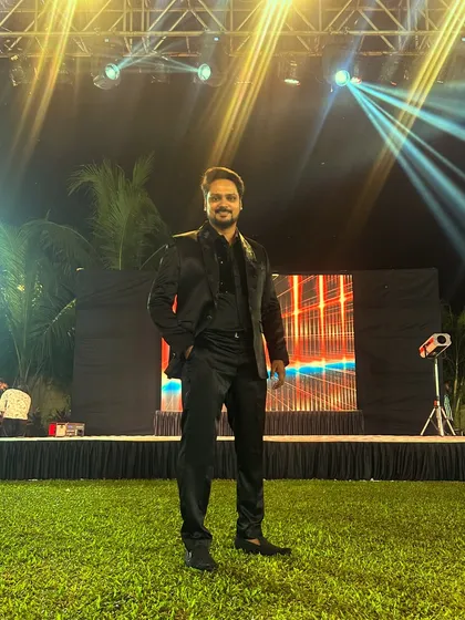 Awaiting the start of an outdoor Sangeet. The stage is set, the lights are on, and I'm ready to bring the energy for a night of performances and dancing.
