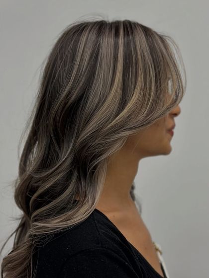 A side view of the ash hair, highlighting the beautiful contrast between the dark base and the light, cool-toned streaks.