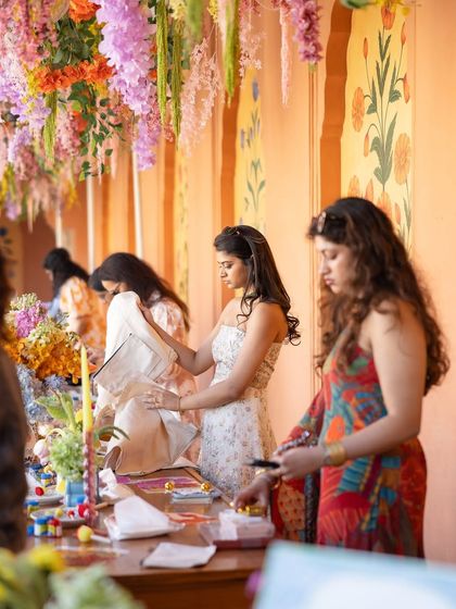 Guests enjoying the interactive art station, painting their own tote bags using traditional Indian folk-art stencils like Pichwai and Warli.