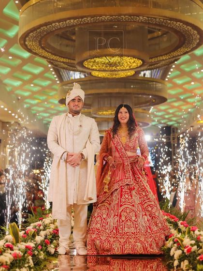 A classic couple entry on a reflective mirror aisle. The cold pyro fountains on either side add a touch of glamour, and I coordinate the timing to make sure the photographers capture the perfect shot.