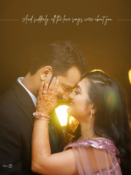 "And suddenly, all the love songs were about you." This intimate close-up, with its warm, soft lighting, focuses on pure emotion and connection, highlighting details like the intricate henna that tells a deeper story.