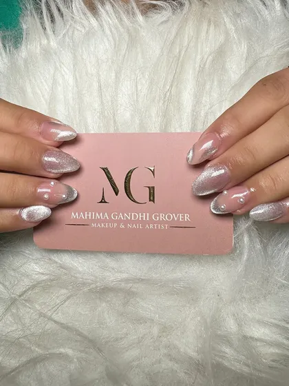 A stunning example of cat eye nail extensions. This design uses magnetic polish to create a shimmering, light-reflecting effect, finished with a glossy top coat for a truly eye catching look.