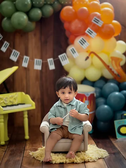 Our little conductor in his mini armchair, surrounded by musical notes and instruments. This is a fun and colorful setup for a music-loving family.