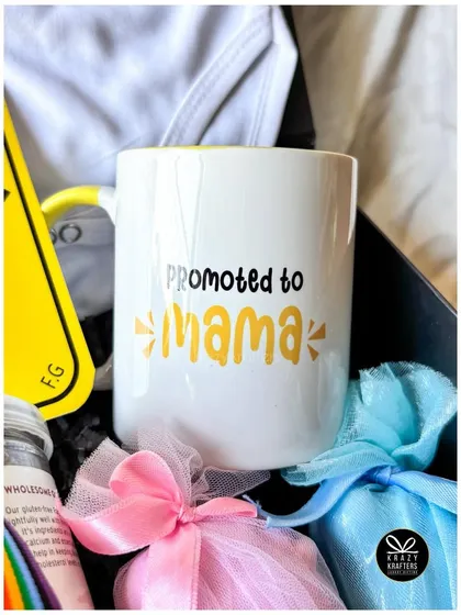 A close-up of the 'Promoted to Mama' mug, part of a rainbow-themed pregnancy announcement hamper that celebrates the journey to motherhood.