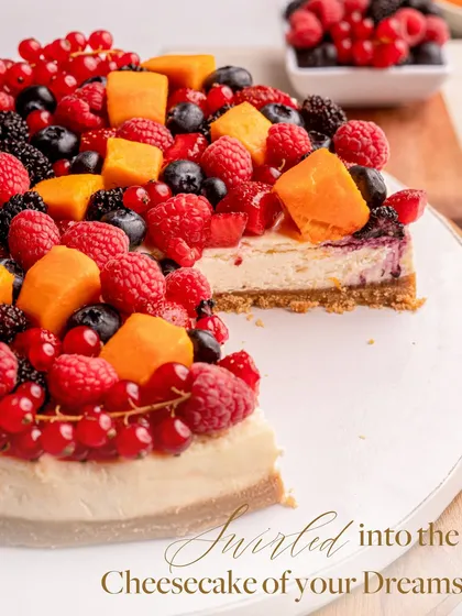 Swirled into the cheesecake of your dreams. My Baked Philadelphia Cheesecake is topped with ripe Alphonsos and vibrant fresh berries for a truly memorable dessert.