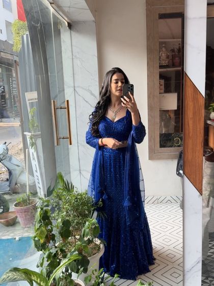 A quick mirror check in the sparkling blue lehenga. This shows my genuine excitement for the outfits I get to wear.