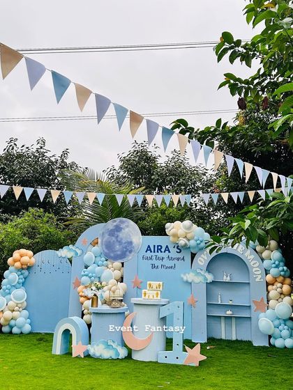 Another angle of the "Over the Moon" party, showcasing the full backdrop, dessert tables, and the large marquee number '1'.
