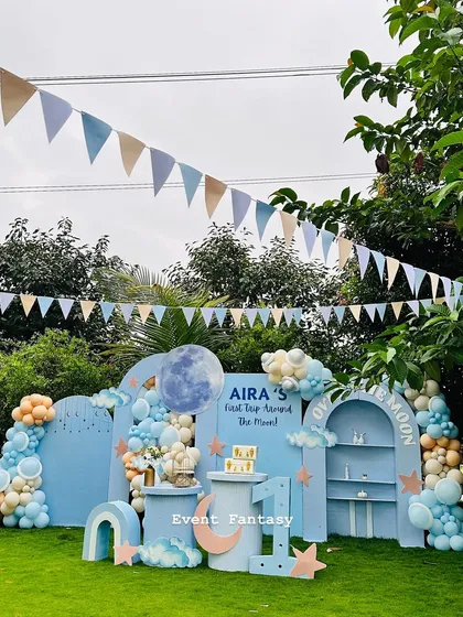 Another angle of the "Over the Moon" party, showcasing the full backdrop, dessert tables, and the large marquee number '1'.