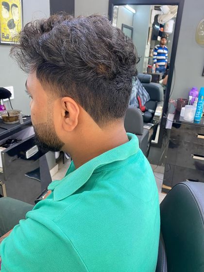 A messy, textured style with a sharp V-taper at the nape. This cut is perfect for a casual, modern look.