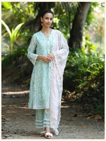 This pastel green kurta set is all about subtle elegance. The all-over white embroidery and lace details make it a delicate and beautiful choice.