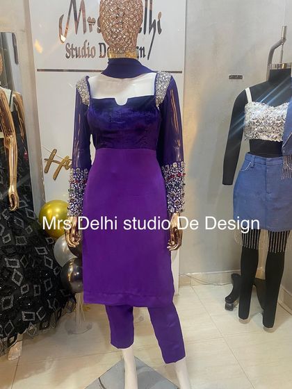 A unique and royal hand-worked traditional suit. This purple velvet suit features stunning multi-colored stone embroidery on the sleeves and shoulders for a truly regal look.