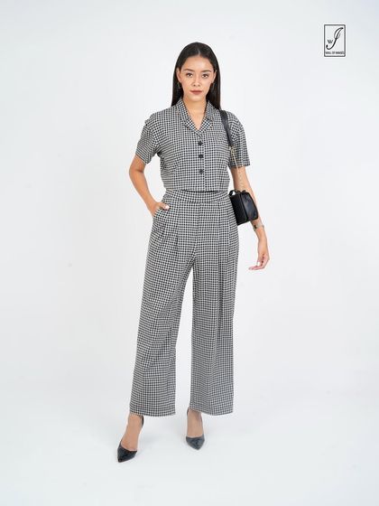 The same outfit styled with a handbag, showing its versatility for a professional or smart-casual setting.