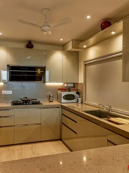 A wide shot of the C-shaped acrylic kitchen, highlighting its spacious layout and modern aesthetic.