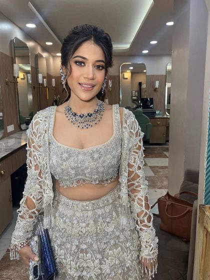 This client looks so happy and confident. The soft glam makeup is perfect for her elegant silver lehenga.