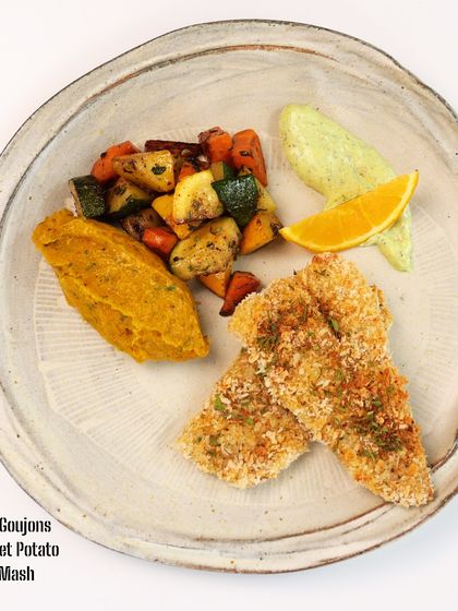 British Pub Fare, Elevated: Sole Fish Goujons: Goujons are a British classic. We make ours with delicate sole fish, coated and baked instead of fried, and serve them with a nutrient-dense sweet potato pumpkin mash and herbed vegetables.