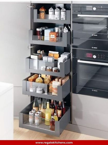 An example of our integrated pantry drawers. These deep, pull-out drawers are hidden behind a single cabinet door, maintaining a seamless exterior look while providing highly organized and accessible storage.