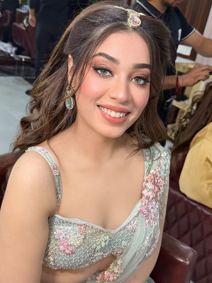 A close-up of this celebrity-inspired look. The makeup is fresh and youthful, and her smile is absolutely radiant.