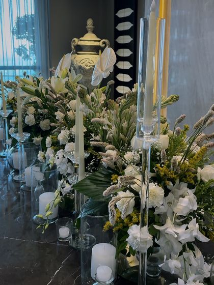 A side view of the long Diwali floral centerpiece, showing the mix of different white flowers and green foliage we used to create texture and depth.