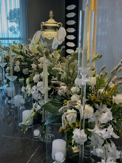 A side view of the long Diwali floral centerpiece, showing the mix of different white flowers and green foliage we used to create texture and depth.