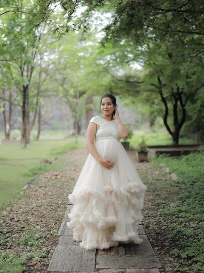 A solo portrait in our ivory ruffled gown. The layers of tulle create beautiful texture and movement, making it a favorite for outdoor shoots.