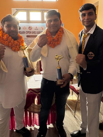 Standing with fellow champions and officials. The spirit of competition and mutual respect is what builds a strong martial arts community.