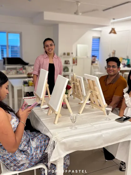 The setup for our couples' painting night, with canvases, paints, and drinks ready for a creative evening.