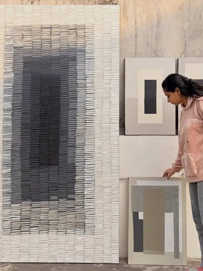 Here I am with a set of artworks just before they were shipped to a client in Surat. I handle everything from small canvases to massive pieces like this 8-foot-tall painting, ensuring each one is just right for the space it's going to live in.