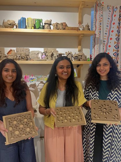 A repeat of image 79, showcasing the beautiful clay cutwork tiles made by three participants.