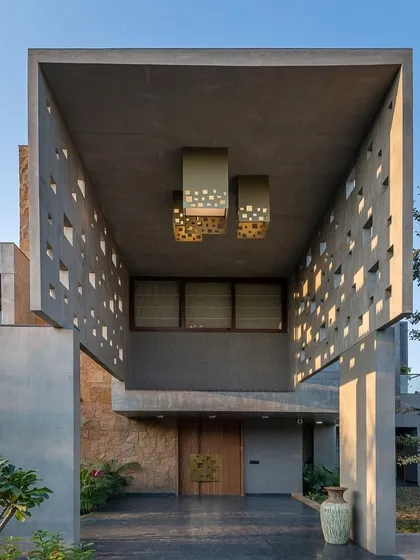 The entrance to your home sets the tone for everything else. For this project, I designed a commanding entryway with perforated concrete walls that create beautiful light patterns, offering a glimpse of the architectural detail within.