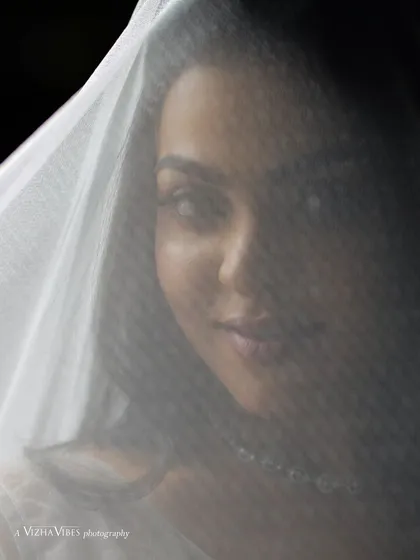 A creative shot of a model with a white veil, creating a beautiful and artistic Christian wedding portrait.