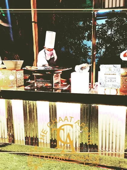 Our luxury setups feature clean lines and warm lighting, creating an inviting atmosphere for guests. This image shows our chefs at their stations, ready to serve the best chaat in Delhi NCR.