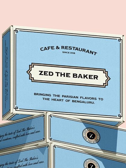 Another view of the stacked blue boxes, highlighting the elegant branding.