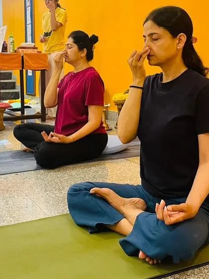 Participants practice Anuloma Viloma (alternate nostril breathing) during a class. This pranayama technique is excellent for calming the mind and balancing the nervous system.