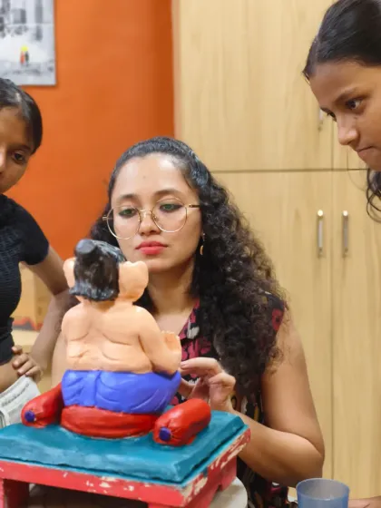 Under the guidance of our instructors, students learn to add fine details and expressions to their sculptures. These young artists are focused on painting their Ganpati idol, learning about color and finishing techniques.