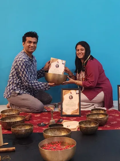 The path of a sound healer begins with dedication and an open heart. Here, a student receives her Sound Healing Teacher Training certificate, surrounded by the Tibetan singing bowls that are central to this deeply vibrational and healing practice.