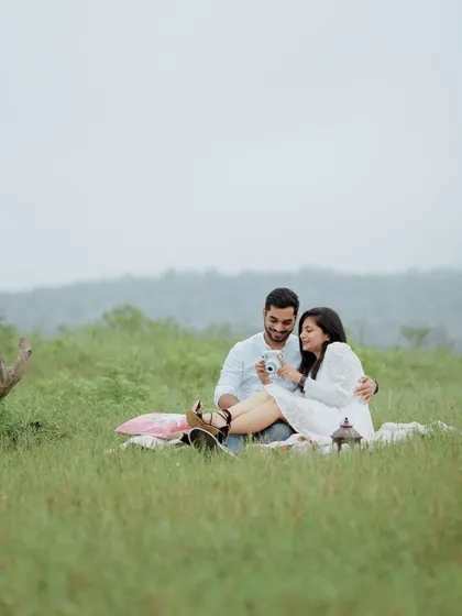 A candid moment from a picnic, where the couple shares a laugh while looking at photos on their camera. It’s these real moments I love to frame.