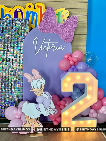 Another detail shot of the Daisy Duck setup, focusing on the light-up number '2' and personalized name sign.