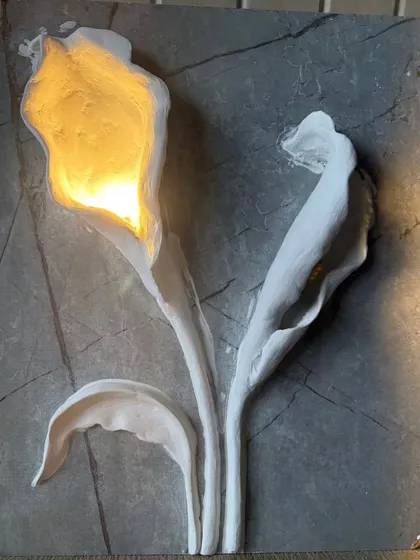 Here, I combined sculpture with function. This 3D floral wall art features hand-sculpted calla lilies on a stone-textured base, with integrated lighting that casts a warm, elegant glow, turning the wall into a statement piece.