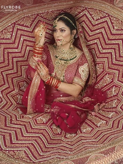 Every detail matters on your wedding day. This shot highlights the beautiful hand jewellery and intricate embroidery of the blouse, part of the complete bridal look you can rent.