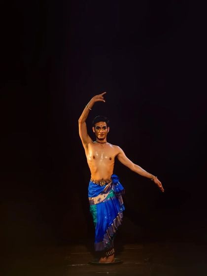 A graceful pose from my performance at the Nrityaangan Samarpan Festival. The dark background highlights the sculptural quality of the body, a key visual aspect of a solo recital.