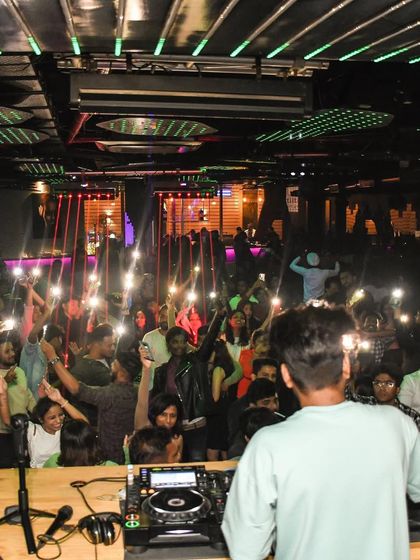 The crowd at Helium Pune with their phone lights up, creating a magical atmosphere.