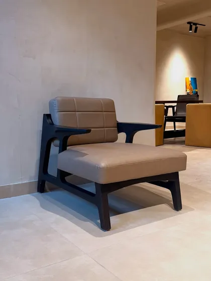 I love highlighting the beauty of natural materials. This armchair features a solid wood frame treated with the Japanese Shou-Sugi-Ban technique, which chars the wood to reveal its stunning grain. Paired with chocolate-colored leatherette, it's a classic piece with a modern, handcrafted twist.