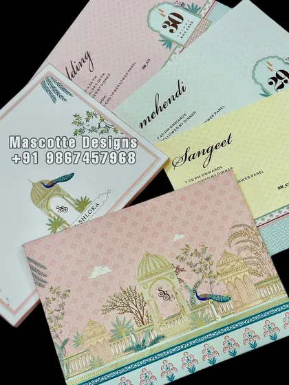 A Pichwai theme hardback wedding invite in a lovely pastel color combination. The card features elegant peacocks and traditional motifs, perfect for a sophisticated wedding.