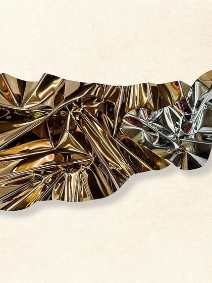 "Meteor 142" is an abstract wall sculpture that appears like a sheet of liquid metal frozen in a moment of movement.