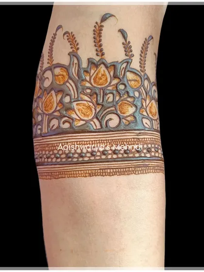 A close-up of a beautiful lotus border design on the arm, showcasing the fine lines and shading techniques I use.